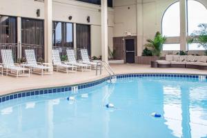 a swimming pool in a hotel with lounge chairs at Clarion Hotel Downtown Nashville - Stadium in Nashville