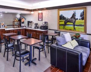 a restaurant with tables and a horse painting on the wall at Econo Lodge Inn & Suites in Shelbyville