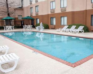 a large swimming pool with chairs and a building at Sleep Inn Arlington Near Six Flags in Arlington