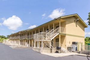 a building with stairs on the side of it at HillView Inn at Six Flags Fiesta in San Antonio