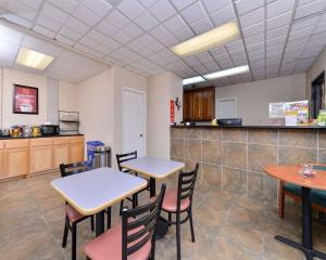 ein Zimmer mit 2 Tischen und Stühlen sowie einer Küche in der Unterkunft Econo Lodge in Killeen