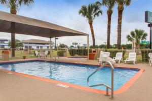 a swimming pool with a slide in a resort at Quality Inn & Suites I-35 near Frost Bank Center in San Antonio