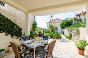 an outdoor dining room with a table and chairs at Apartments Bozica in Dubrovnik