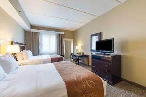 a hotel room with two beds and a flat screen tv at Comfort Suites Beachside in South Padre Island