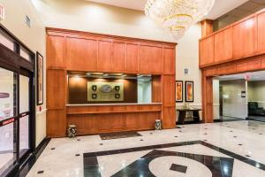 a lobby with a wood paneled wall and a chandelier at Comfort Suites Westchase Houston Energy Corridor in Houston