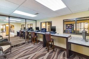 a lobby with a long bar with stools at Quality Inn & Suites in Lubbock