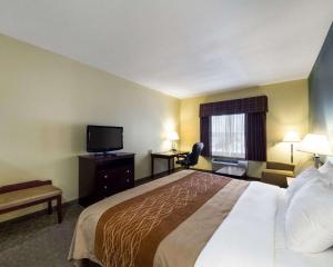 a hotel room with a bed and a flat screen tv at Quality Inn Ingleside - Corpus Christi in Ingleside