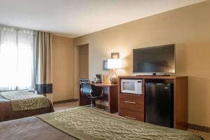a hotel room with a bed and a flat screen tv at Comfort Inn Edinburg South in Edinburg +19 photos