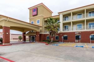 a hotel with a parking lot in front of it at Comfort Suites in Galveston