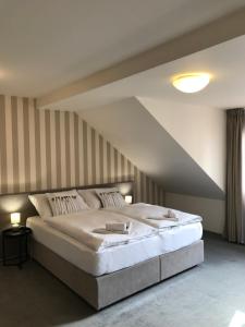 Posteľ alebo postele v izbe v ubytovaní Rozmaryn Hotel B&B
