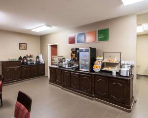a restaurant with a counter with food on it at Comfort Inn & Suites in Red Oak