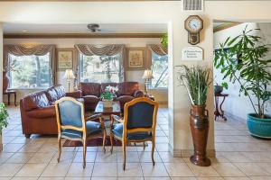 a living room with a couch and a table and chairs at Econo Lodge San Antonio South in San Antonio