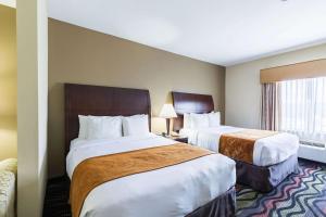 a hotel room with two beds and a window at Comfort Suites Beaumont I-10 in Beaumont +21 photos