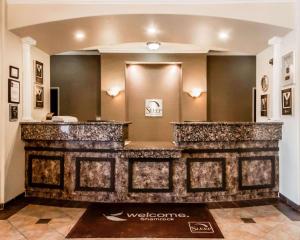 a lobby with a stone counter in a building at Sleep Inn & Suites in Shamrock