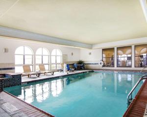 a large swimming pool with blue water in a building at Comfort Suites Fort Stockton in Fort Stockton