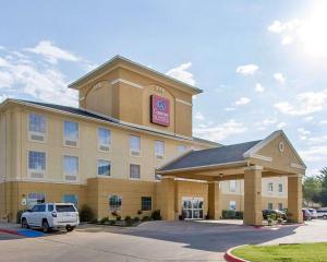 a hotel with a car parked in a parking lot at Comfort Suites Abilene in Abilene