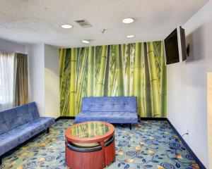 a living room with a couch and a table at Rodeway Inn & Suites Lewisville I-35 in Lewisville