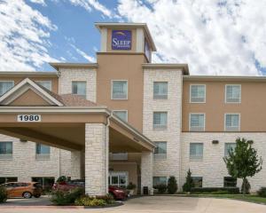 a hotel with a sign on top of it at Sleep Inn and Suites Round Rock - Austin North in Round Rock