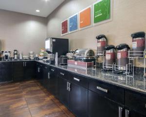 a kitchen with a counter with dishes on it at Comfort Inn & Suites I-10 Airport in El Paso