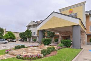 a hotel front of a building with flowers at Comfort Inn & Suites Frisco - Plano in Frisco