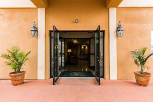 an open door of a building with two potted plants at Quality Inn Killeen Forthood in Killeen