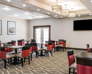 a conference room with tables and chairs and a flat screen tv at Comfort Inn & Suites Pharr/McAllen in Pharr