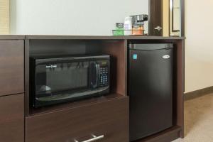 a microwave and a refrigerator in a cabinet at Sleep Inn & Suites Ingleside - Corpus Christi in Ingleside