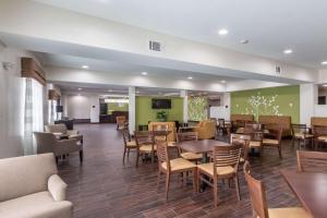 a restaurant with tables and chairs in a room at Sleep Inn & Suites College Station in College Station