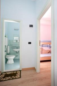 a bathroom with a toilet and a sink at Hotel Vallechiara in Cesenatico