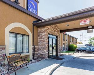 a building with a bench in front of a store at Sleep Inn South Jordan-Sandy in South Jordan
