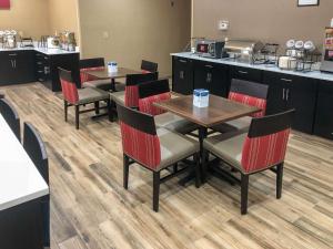 a restaurant with tables and chairs and a kitchen at Comfort Inn Wichita Falls Near University in Wichita Falls