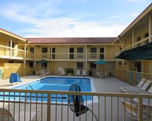 a hotel with a swimming pool in front of a building at Quality Inn Harlingen in Harlingen