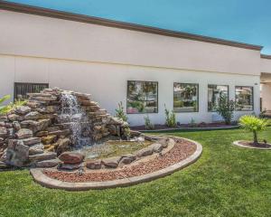 a waterfall in a yard in front of a building at Econo Lodge St George North - Near Pioneer Park in St. George