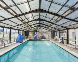 an indoor swimming pool with a glass ceiling at Sleep Inn South Jordan-Sandy in South Jordan