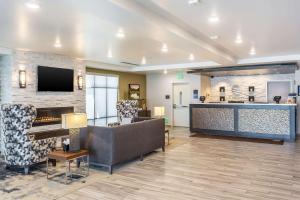 a living room with a couch and a fireplace at Comfort Inn & Suites Salt Lake City Airport in Salt Lake City