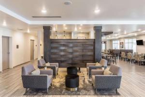a lobby with chairs and tables and a bar at Comfort Inn & Suites Salt Lake City Airport in Salt Lake City
