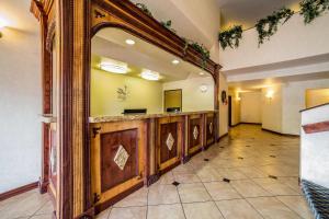 a hotel lobby with a mirror and a reception desk at Quality Inn Zion Park Area in Hurricane +23 photos
