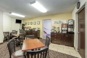 a restaurant with tables and chairs and a kitchen at Sleep Inn Provo near University in Provo