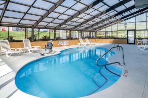 a large swimming pool with chairs in a building at Quality Inn & Suites in Wytheville
