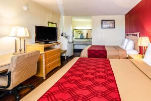 a hotel room with two beds and a flat screen tv at Econo Lodge Christiansburg-Blacksburg I-81 in Christiansburg
