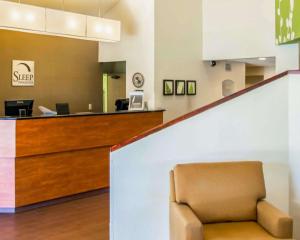 a waiting room with a chair in front of a counter at Sleep Inn Fredericksburg North in Fredericksburg