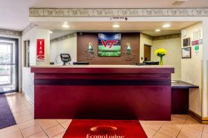 a bar in a hotel lobby with a red counter at Econo Lodge Christiansburg-Blacksburg I-81 in Christiansburg