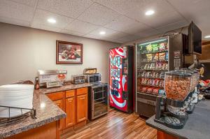 a kitchen with a soda machine and a refrigerator at Econo Lodge Metro in Arlington