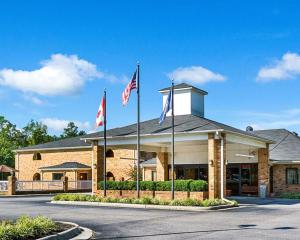 a building with three flags in front of it at Quality Inn Petersburg Near Fort Gregg-Adams in Southern Estates