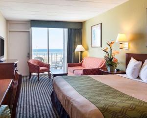 a hotel room with a bed and a view of the ocean at Ocean27 Hotel in Virginia Beach