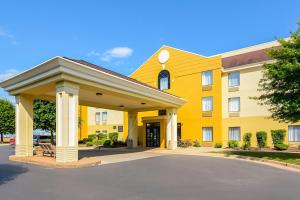 a large yellow building with a parking lot at Comfort Inn Woodstock Shenandoah in Woodstock
