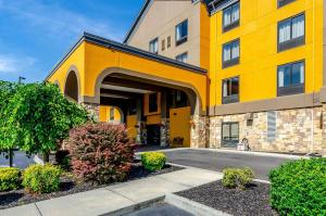 a large yellow building with bushes in front of it at Quality Inn & Suites Abingdon in Abingdon