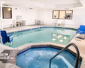 a large indoor pool with chairs and chairs at Sleep Inn & Suites Monticello in Charlottesville