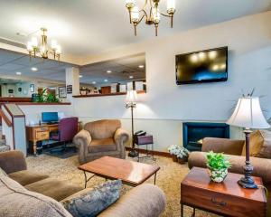 a living room with couches and a fire place at Quality Inn Christiansburg - Blacksburg in Christiansburg