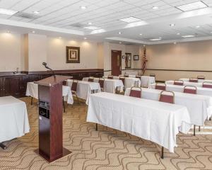 a banquet hall with white tables and chairs and a podium at Comfort Inn Near Quantico Main Gate North in Dumfries